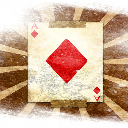 grunge playing card on a soft brown backgroundの写真素材