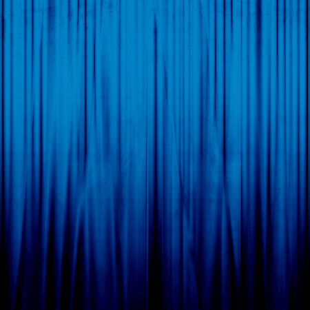 blue movie or theatre curtain with a bright spotlightの写真素材