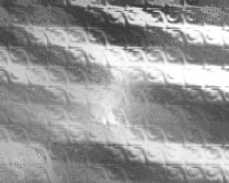 Brushed metal plate with reflected lightの写真素材