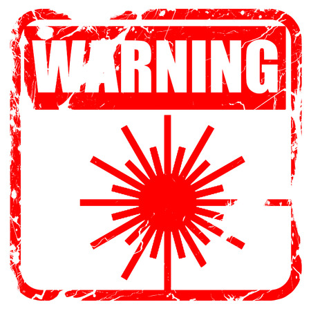 Laser warning sign with some soft spots and highlights, red rubber stamp with grunge edgesの写真素材