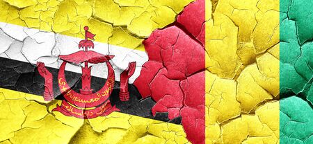 Brunei flag with Guinea flag on a grunge cracked wallの写真素材