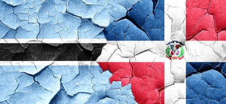 Botswana flag with Dominican Republic flag on a grunge cracked wallの写真素材