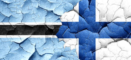 Botswana flag with Finland flag on a grunge cracked wallの写真素材