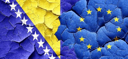 Bosnia and Herzegovina flag with european union flag on a grunge cracked wallの写真素材