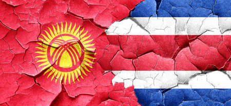 Kyrgyzstan flag with Costa Rica flag on a grunge cracked wallの写真素材