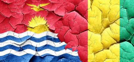 Kiribati flag with Guinea flag on a grunge cracked wallの写真素材