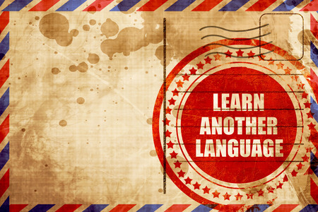 learn another language, red grunge stamp on an airmail backgroundの写真素材