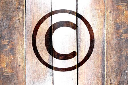 Vintage copyright symbol on a grunge wooden panelの写真素材