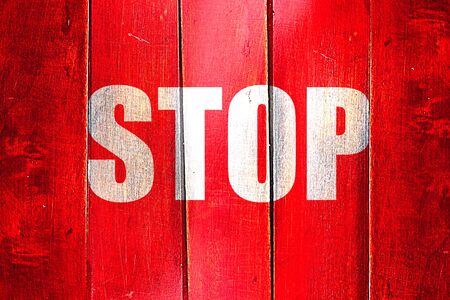 Vintage stop sign on a grunge wooden panelの写真素材