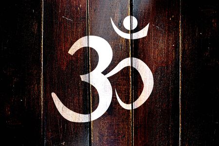 Vintage Om / aum symbol on a grunge wooden panelの写真素材