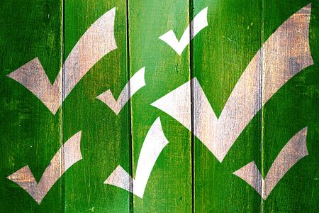 Vintage Approved tick with smooth lines and vivid colors on a grunge wooden panelの写真素材