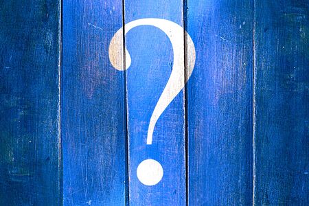 Vintage question mark on a grunge wooden panelの写真素材
