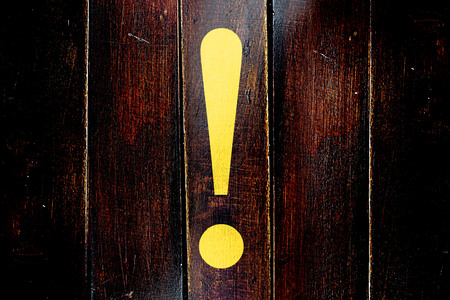 Vintage Hazard warning sign on a grunge wooden panelの写真素材