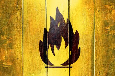 Vintage Flammable hazard sign on a grunge wooden panelの写真素材