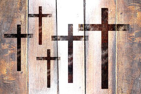 Vintage Christian cross icon on a grunge wooden panelの写真素材