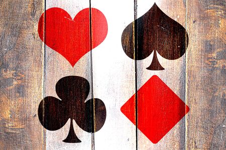 Vintage card game symbols on a grunge wooden panelの写真素材