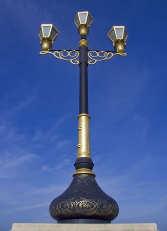 Artistic and Decorative Black and Gold Metal Post with three bulbsの写真素材