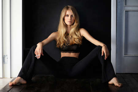 Beautiful woman sitting at the floorの写真素材