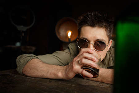 Man drinking alcohol at the table