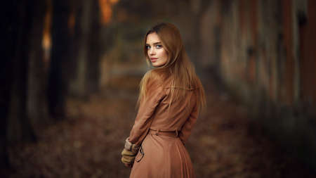 Young female model in autumn parkの写真素材