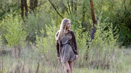 Young girl posing in spring forestの写真素材