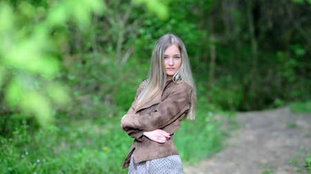 Young girl posing in spring forestの写真素材