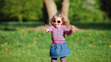 Beautiful girl playing outdoorの写真素材