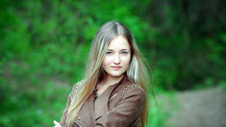 Closeup portrait of romantic fashion young woman smile in the woods の写真素材