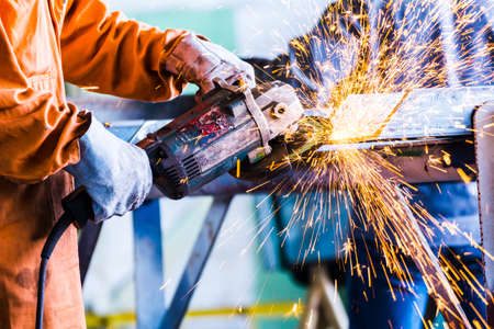 Electric wheel grinding on steel structure construction plant
