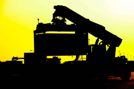  Silhouette of port warehouse with container cargo and forkliftの写真素材