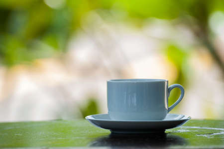 coffee cup on wood over nature backgroundの写真素材