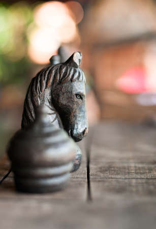 wooden Black horse chess on a chess boardの写真素材