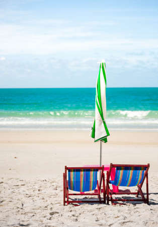 Beach chair and umbrella on sand beach. Concept for rest, relaxation, holidays, spa, resort.の写真素材