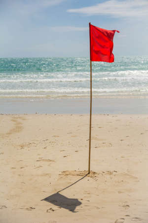 Red flag on the beachの写真素材