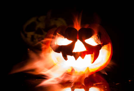 Halloween - old jack-o-lantern on black backgroundの写真素材