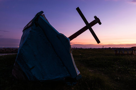 The old fishing boat over a sunset or sunrise skyの写真素材