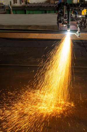 metal cutting with plasma torch close-up on low ligth