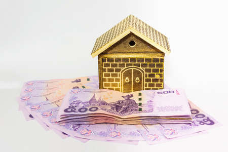 The house on pile of money. Concept of real estate.の写真素材