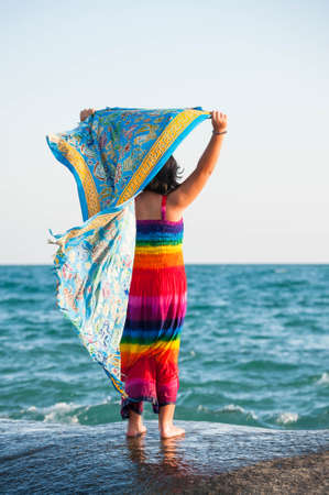 little girl with colorful dress at tropical beachの写真素材