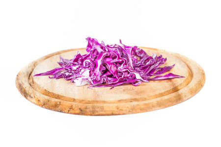 Closeup of Chopped Red Cabbage on Wooden Cutting Board on white backgroundの写真素材
