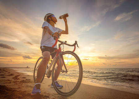 Cycling outdoors against sunsetの写真素材