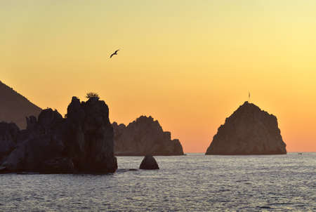 Silhouettes of rocks on The black sea in the village of Gurzuf. The Golden color of the sky at dawn. Russia, nature of Crimea, 2019の写真素材
