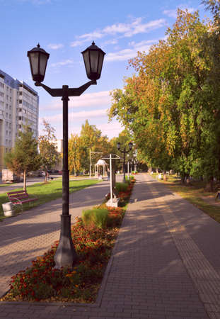 Boulevard on Vertkovskaya with a lantern. Footpath, green lawns and trees in the city landscaped Park. Russia, Siberia, Novosibirsk, 2019の写真素材
