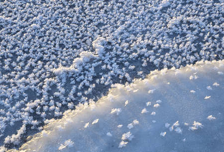 Large snowflakes close-up on the first blue ice of the river. Pure snow crystals. Abstract blue-and-blue background. Nature Of Siberia, 2018の写真素材