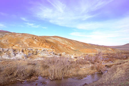 Mars in the Altai Mountains. The slope of the river terrace with the exposure of colorful clays and...
