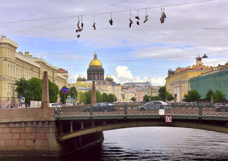 Saint Petersburg / Russia-09.01.2020: sneakers over the Kiss bridge, the dome of St. Isaac's Cathedral in the distance. Student pranksのeditorial素材