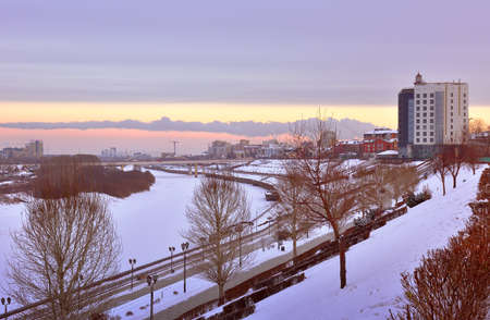 Winter evening in Tyumen. High embankment of the Tura river covered with snow. Siberia, Russia, 2021の写真素材