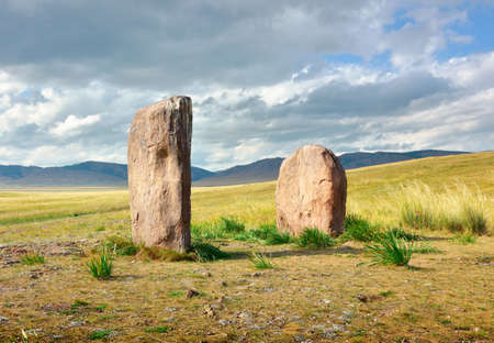 Stone steles in the steppe under a cloudy blue sky. Siberia, Russiaの写真素材