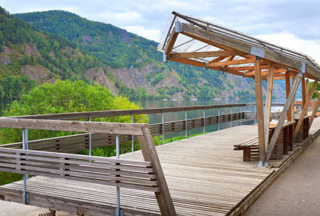 An observation deck with a canopy on the bank of the big Siberian river with rocky shores. Krasnoyarsk Territory, Siberia, Russiaの写真素材