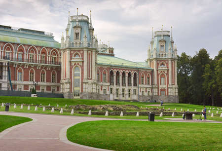 Moscow, Russia, 09.05.2020: Palace and Park ensemble of the XVIII century, architect Vasily Bazhenov. The facade of the "Grand Palace" in pseudo-Gothic style, high towers with an attic and columns, red brick, white stone, a winding granite pathのeditorial素材